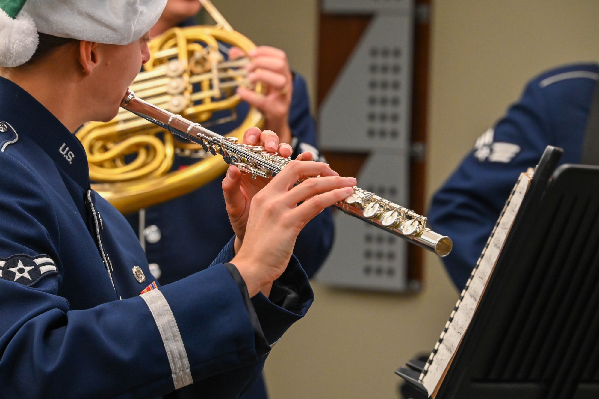 Airman 1st Class Emily Lloyd, U.S. Air Force Band of the West flutist, plays the flute with the U.S. Air Force Band of the West at the 97th Medical Group at Altus Air Force Base, Oklahoma, Dec. 14, 2021. The Airmen assigned to the band are highly-trained professional musicians who have dedicated themselves to serving their country through music. (U.S. Air Force photo by Airman 1st Class Kayla Christenson)