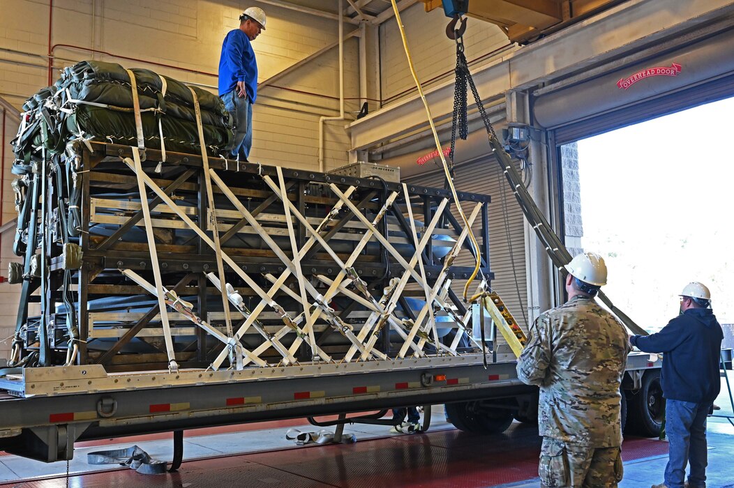 Airmen and Riggers with the 1st Special Operations Squadron Logistics Readiness Squadron load a Rapid Dragon Palletized Weapon System aboard an MC-130J Commando II at Hurlburt Field, Florida, Dec. 13, 2021. The Rapid Dragon Program demonstrates the ability to employ weapons using standard airdrop procedures from cargo aircraft anytime and anywhere. (U.S. Air Force photo by Staff Sgt. Brandon Esau)