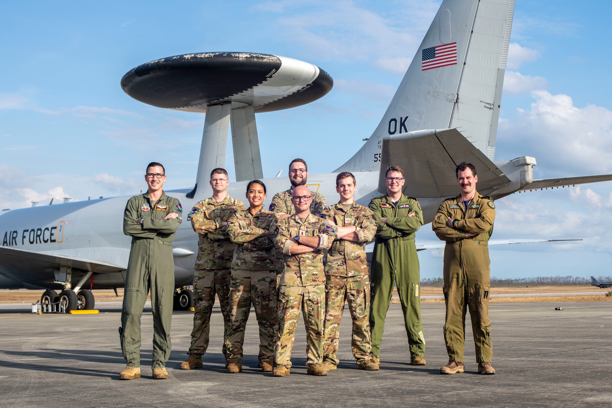 the aircraft crew poses for a photo