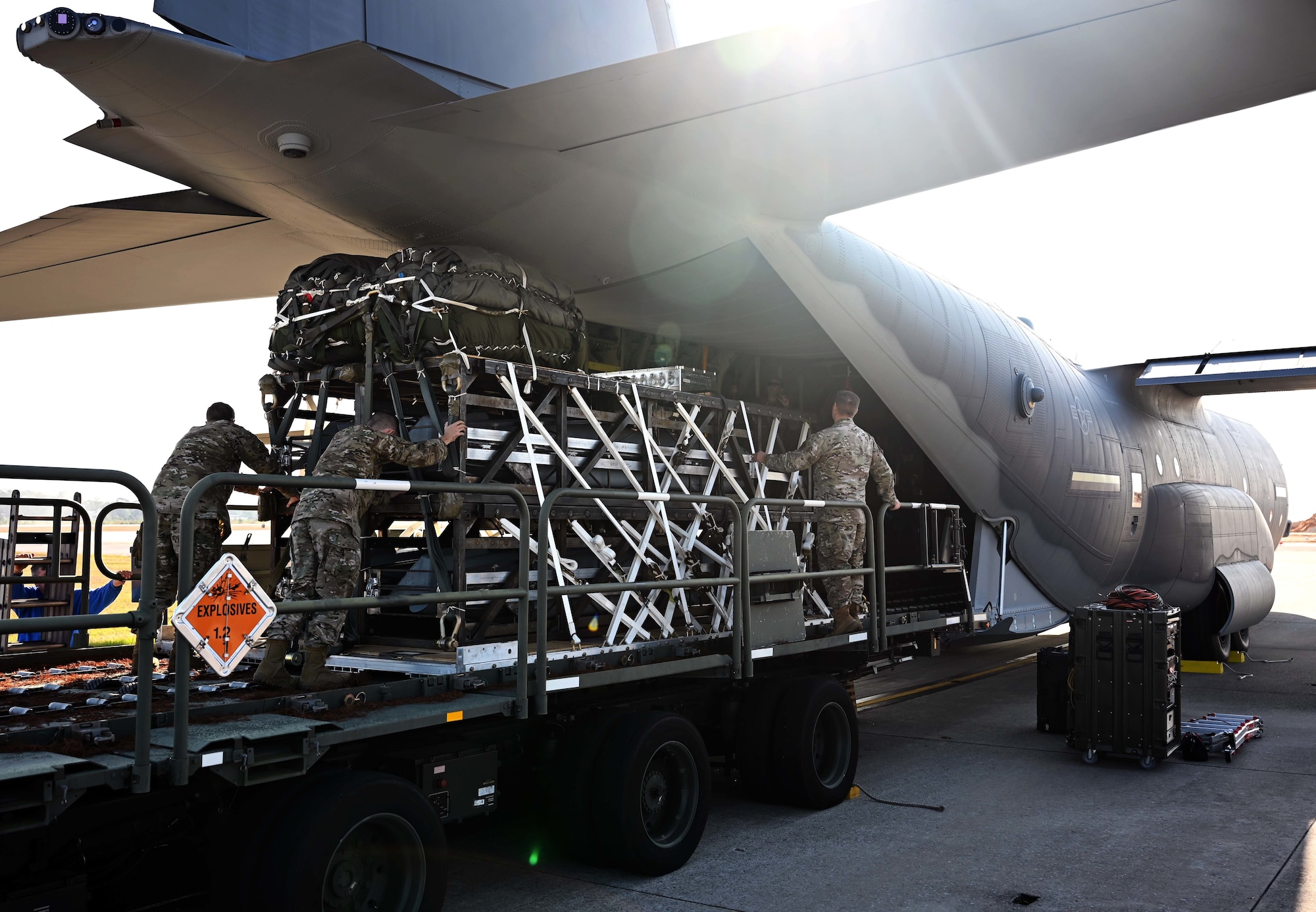 Airmen and Riggers with the 1st Special Operations Squadron Logistics Readiness Squadron load a Rapid Dragon Palletized Weapon System aboard an MC-130J Commando II at Hurlburt Field, Florida, Dec. 13, 2021. The Rapid Dragon Program demonstrates the ability to employ weapons using standard airdrop procedures from cargo aircraft anytime and anywhere. (U.S. Air Force photo by Staff Sgt. Brandon Esau)