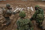 U.S. Marines and soldiers with the Japan Ground Self-Defense Force (JGSDF) prepare to receive an aerial resupply during Resolute Dragon 21, on Ojojihara Proving Grounds, Dec. 10, 2021. RD21 is the largest bilateral field training exercise between the U.S. Marine Corps and JGSDF since 2013 and is the largest ever in Japan. RD21 is designed to strengthen the defensive capabilities of the U.S.-Japan Alliance by exercising integrated command and control, targeting, combined arms, and maneuver across multiple domains.