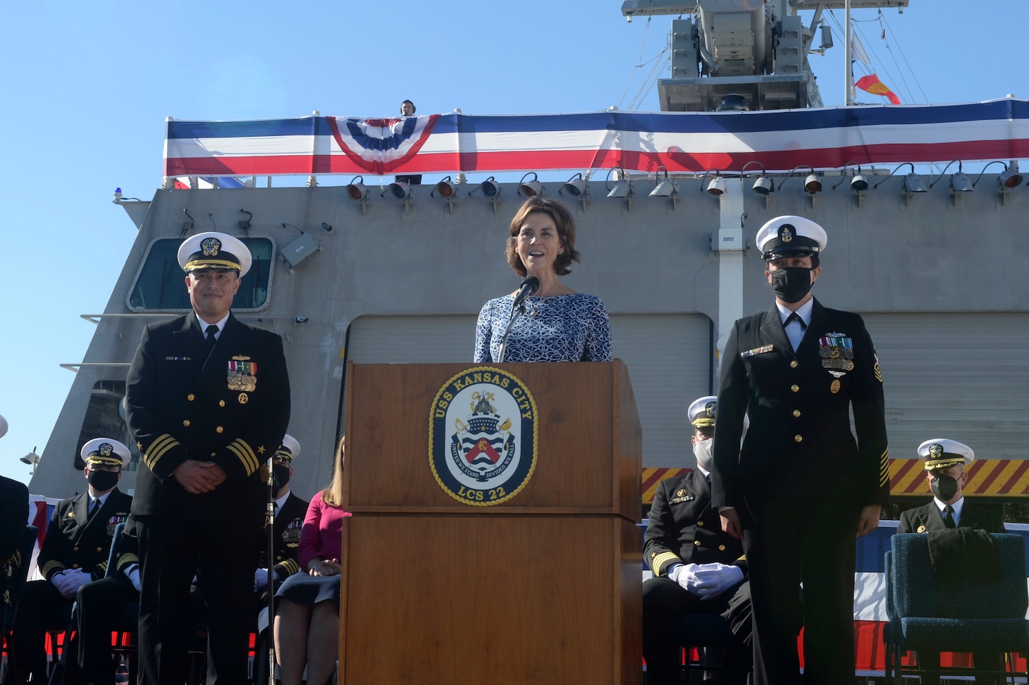 SAN DIEGO (Dec 17, 2021) Tracy Davidson, the ship sponsor of Independence-variant littoral combat ship USS Kansas City (LCS 22) delivers the order to man the ship and bring her to life during a commissioning commemoration ceremony on the flight deck. The Navy commissioned LCS 22, the second ship in naval history to be named Kansas City, via naval message due to public health safety and restrictions of large public events related to the novel coronavirus (COVID-19) pandemic. Kansas City is homeported at Naval Base San Diego. (U.S. Navy photo by Mass Communication Specialist 2nd Class Vance Hand/Released)