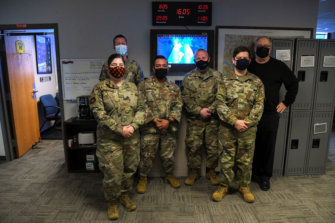 Members of the 21st Logistics Readiness Squadron weather flight pose for a photo in their office on Peterson Space Force Base, Colorado, Dec. 9, 2021. The 21st LRS weather flight tailors space-weather data gathered by the 2nd Weather Squadron, headquartered at Offutt Air Force Base, Nebraska, to brief operational U.S. Space Force units across the Front Range and Peterson-Schriever Garrison’s geographically separated units around the globe.