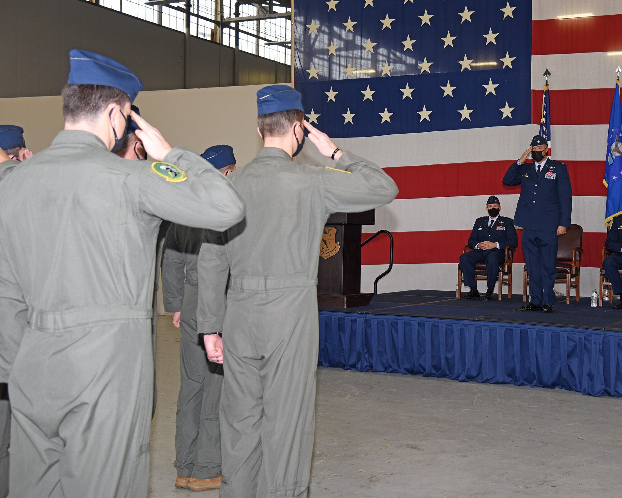 Members of the 49th Fighter Training Squadron salute Lt. Col. Aaron Jones, 49th FTS incoming commander Dec. 16, 2021, on Columbus Air Force Base, Miss. The 49th FTS teaches newly graduated fighter pilots by operating the T-38 Talon aircraft to conduct flight training as well as fighter fundamentals. (U.S. Air Force photo by Elizabeth Owens)