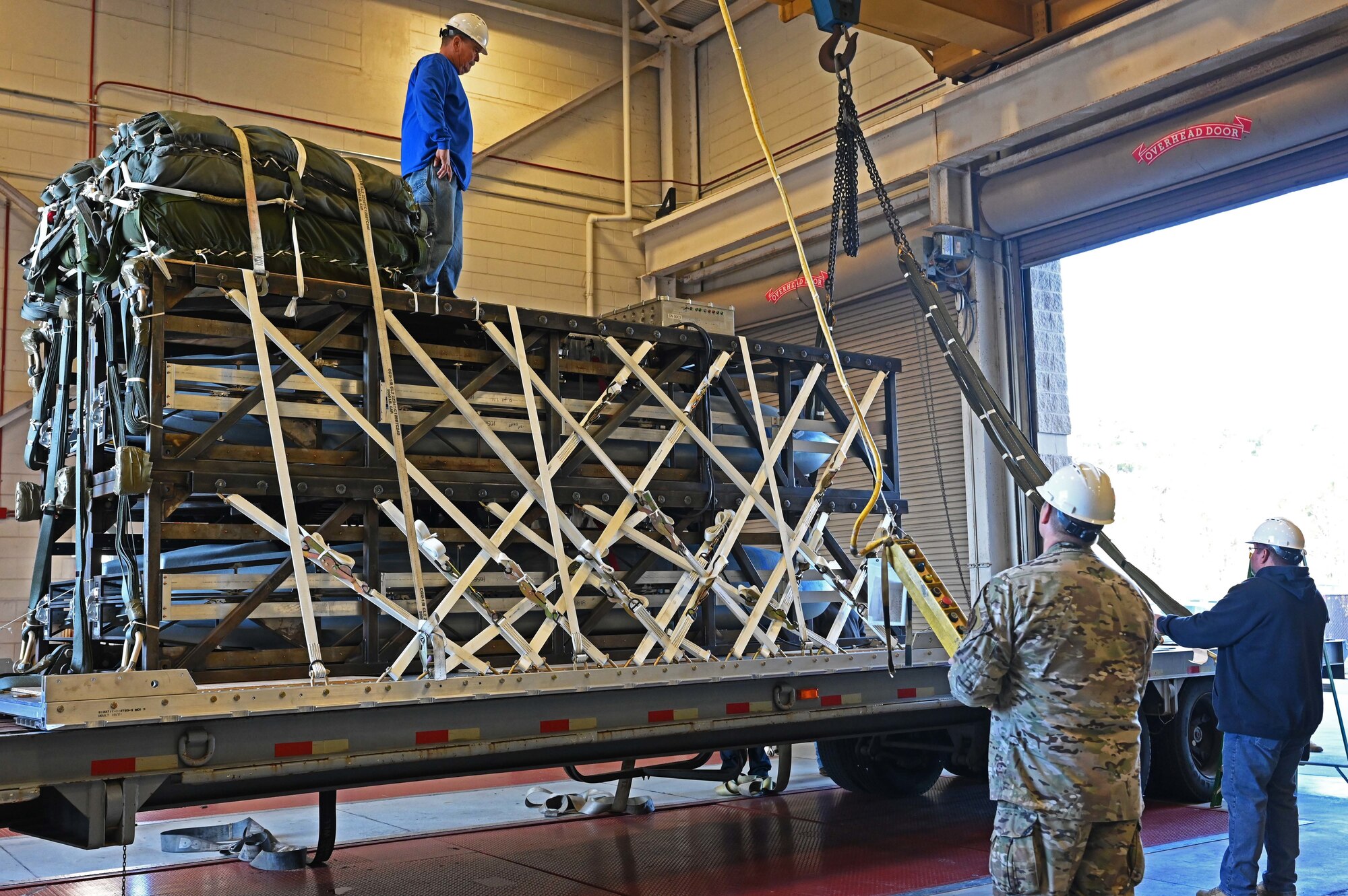 Airmen and Riggers with the 1st Special Operations Squadron Logistics Readiness Squadron load a Rapid Dragon Palletized Weapon System aboard an MC-130J Commando II at Hurlburt Field, Florida, Dec. 13, 2021. The Rapid Dragon Program demonstrates the ability to employ weapons using standard airdrop procedures from cargo aircraft anytime and anywhere. (U.S. Air Force photo by Staff Sgt. Brandon Esau)
