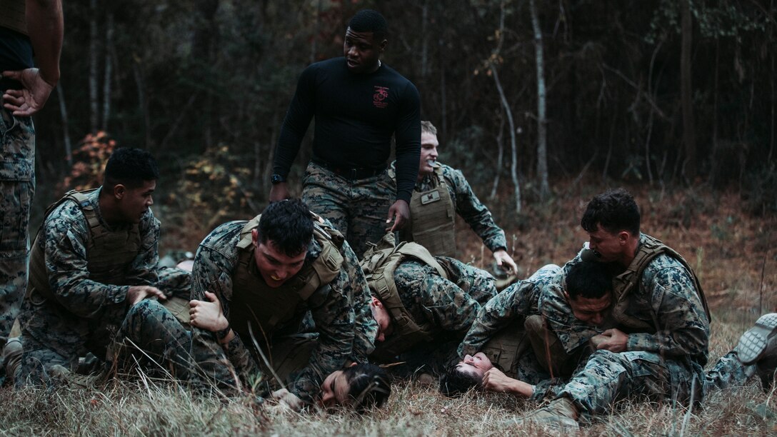 U.S. Marines with 2d Marine Division grapple during Marine Corps Martial Arts Instructor (MAI) Course 123-22 on Camp Lejeune, N.C., Dec. 7, 2021. The course’s multistation culminating event challenged the students’ strength, determination, and skills needed to become an MAI. (U.S. Marine Corps photo by Lance Cpl. Jacqueline C. Arre)