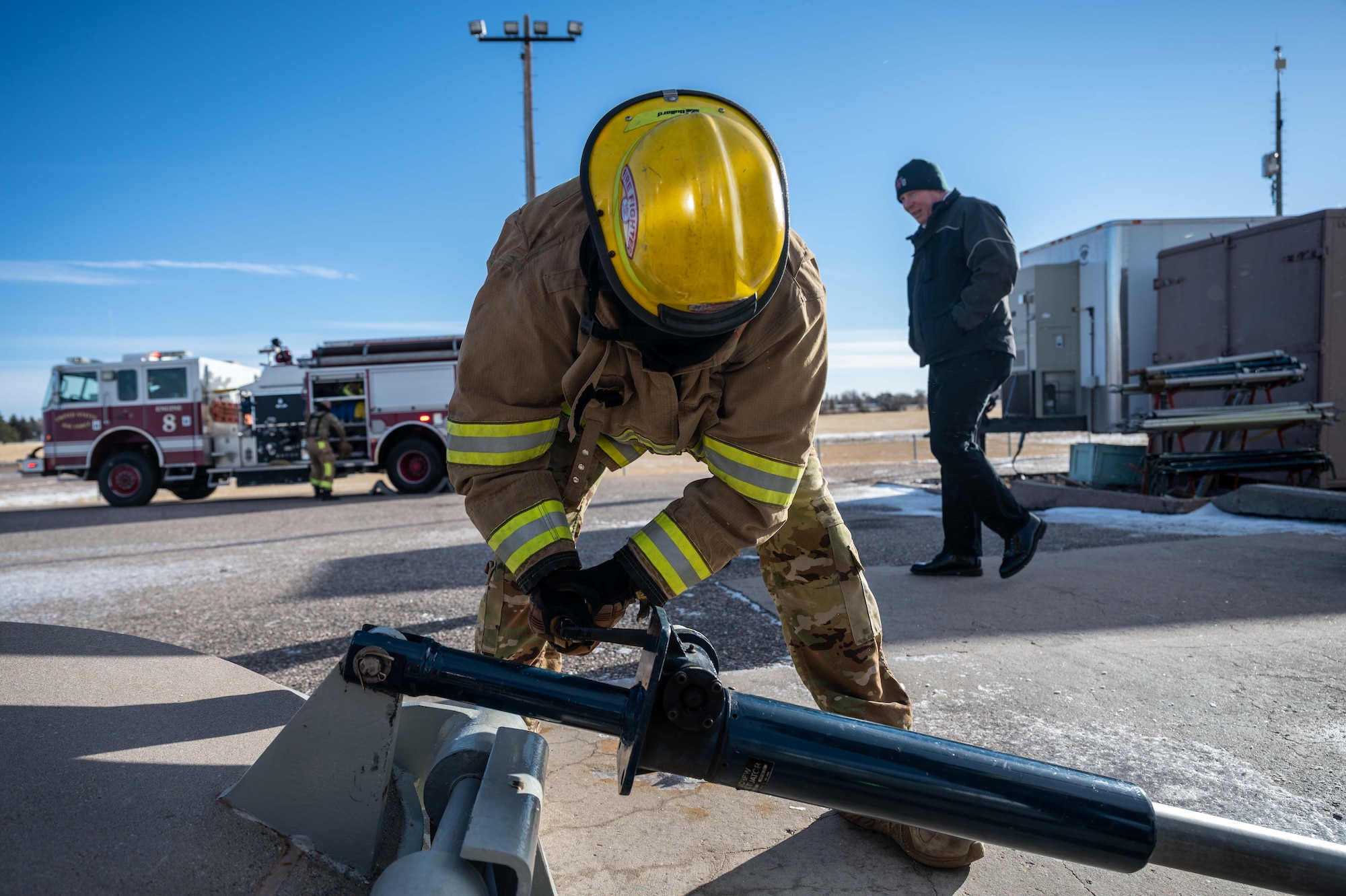 firefighters cranks a shaft.