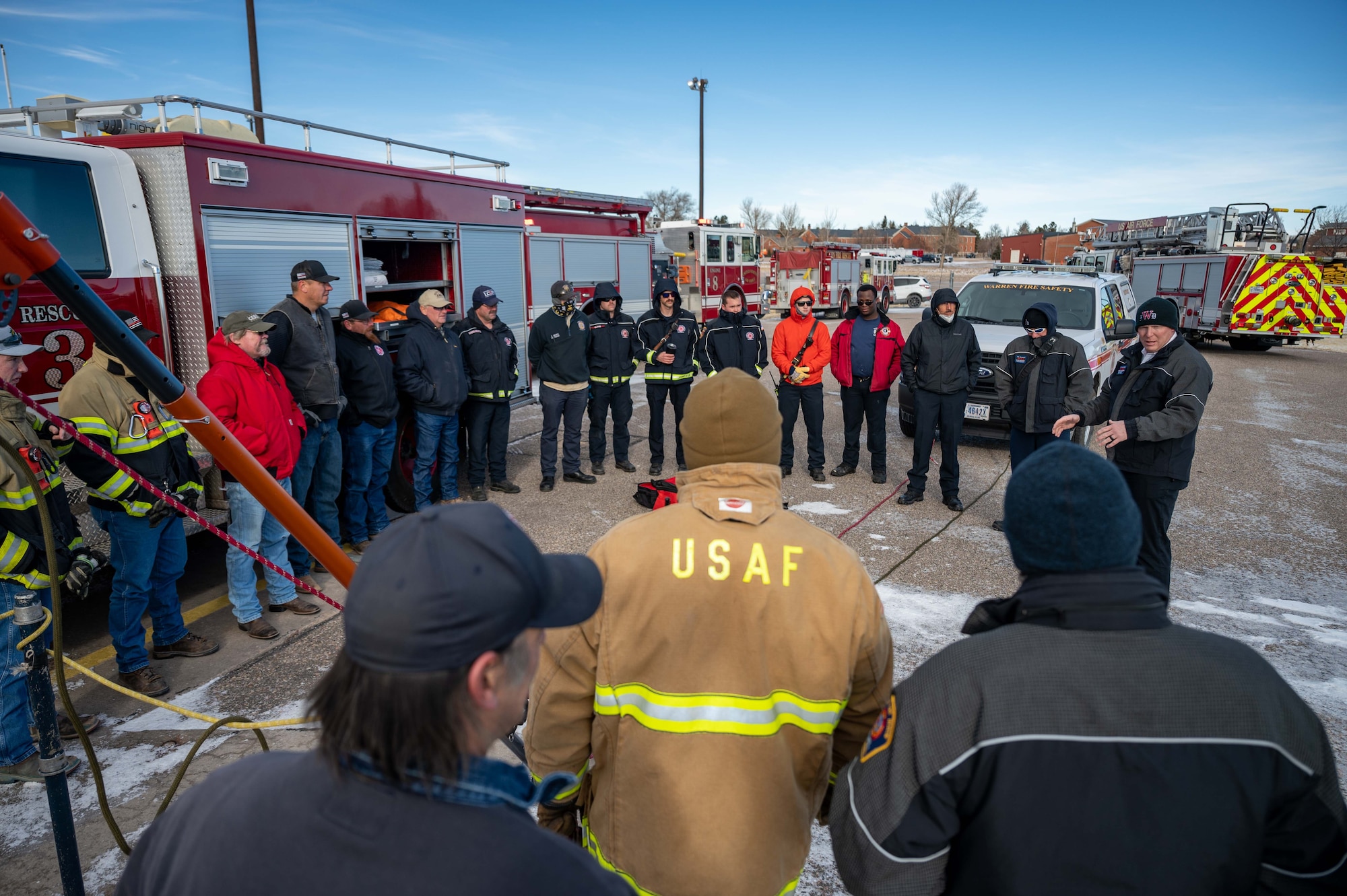 firefighters stand around in a circle