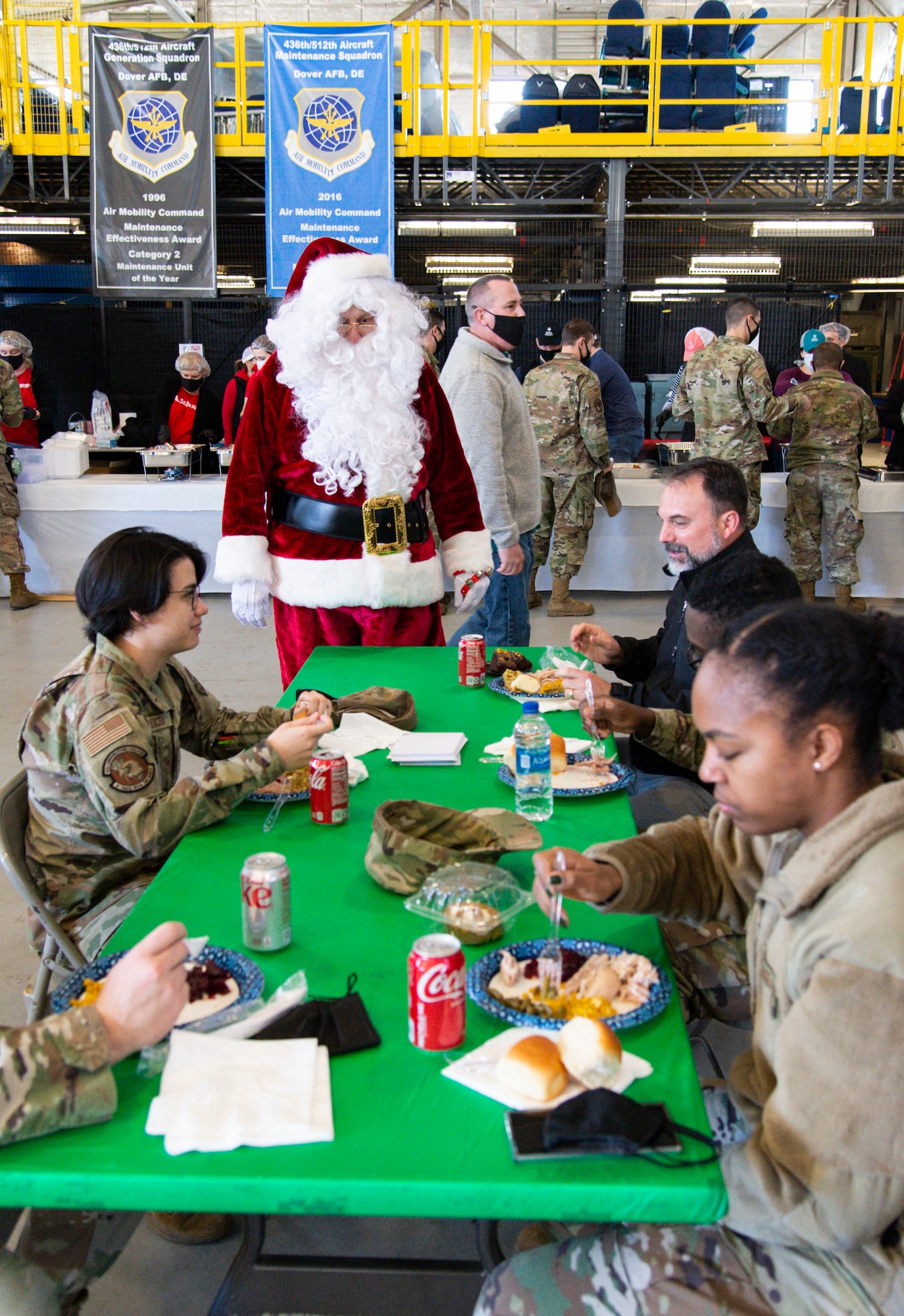 Santa Claus speaks with Team Dover Airmen during Operation Feed the Troops on Dover Air Force Base, Delaware, Dec. 14, 2021. OFTT volunteers served a traditional holiday meal to more than 900 Team Dover members. (U.S. Air Force photo by Roland Balik)