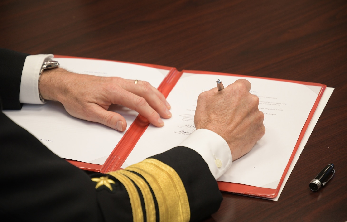 Vice Adm. Bill Merz signs the Strategic Interoperability Framework at the French Defense Attaché Office in Washington, D.C. Dec. 17.