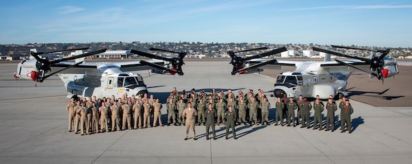Personnel assigned to the “Sunhawks” of VRM 50 pose for a group photo in front of two CMV-22B Ospreys on the flight line on board Naval Air Station North Island. VRM-50, the Navy’s first CMV-22B Osprey Fleet Replacement Squadron, received their safe-for-flight certification on Dec. 16 and will begin training students in May of 2022. (U.S. Navy Photo/ MC2 Chelsea D. Meiller