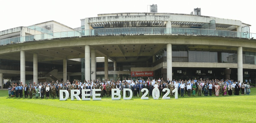 Participants gather for a group photograph during day one of the 2021 Bangladesh Disaster Response Exercise and Exchange (DREE), Dhaka, hosted by The Bangladesh Ministry of Disaster Management and Relief (MoDMR), Bangladesh Armed Forces Division (AFD), and the United States Army Pacific (USARPAC), at Dhaka, Bangladesh on Oct. 26, 2021. The DREE brings together over 30 countries working in partnership (or collaboration) with government and non-government organizations to compare best practices for disaster relief, culminating in a table-top exercise to simulate a large-scale earthquake response.