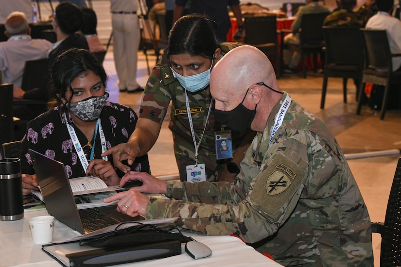 U.S. Army Lt. Col. Chris Herion works with others in a cell groups as part of the table-top exercise during the second day of the Bangladesh Disaster Response Exercise and Exchange (DREE) 2021 hosted by The Bangladesh Ministry of Disaster Management and Relief (MoDMR), Bangladesh Armed Forces Division (AFD), and the United States Army Pacific (USARPAC), at Dhaka, Bangladesh on Oct. 27, 2021. The DREE brings together over 30 countries working in partnership (or collaboration) with government and non-government organizations to compare best practices for disaster relief, culminating in a table-top exercise to simulate a large-scale earthquake response.