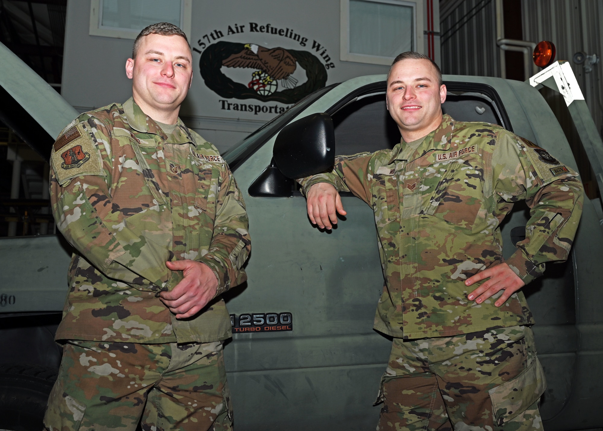 From left, Tech. Sgt. Sean Wood and Staff Sgt. Christopher Wood, vehicle maintainers with the 157th Air Refueling Wing, pose in their flight maintenance facility Dec. 15, 2021, at Pease Air National Guard Base.