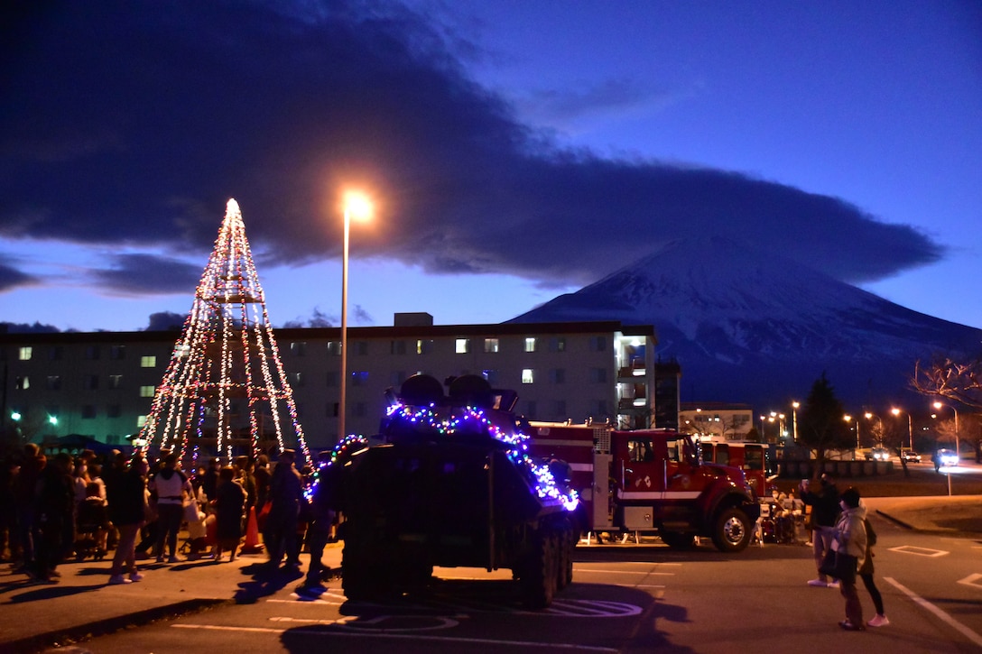 Combined Arms Training Center Camp Fuji personnel and members of the local community enjoy music and lights at the installation’s Christmas tree lighting ceremony, Shizuoka, Japan, Dec. 12, 2021. CATC Camp Fuji hosted the ceremony for installation personnel and the local community, which included games, entertainment, a tree lighting, and a visit from Santa. (U.S. Marine Corps photo by Katie Gray)