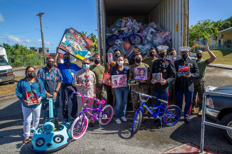 U.S. Marines assigned to Marine Corps Base (MCB) Camp Blaz and local community members pose for a group photo during a Toys for Tots toy transfer event to local charities on Guam, Dec. 17, 2021.