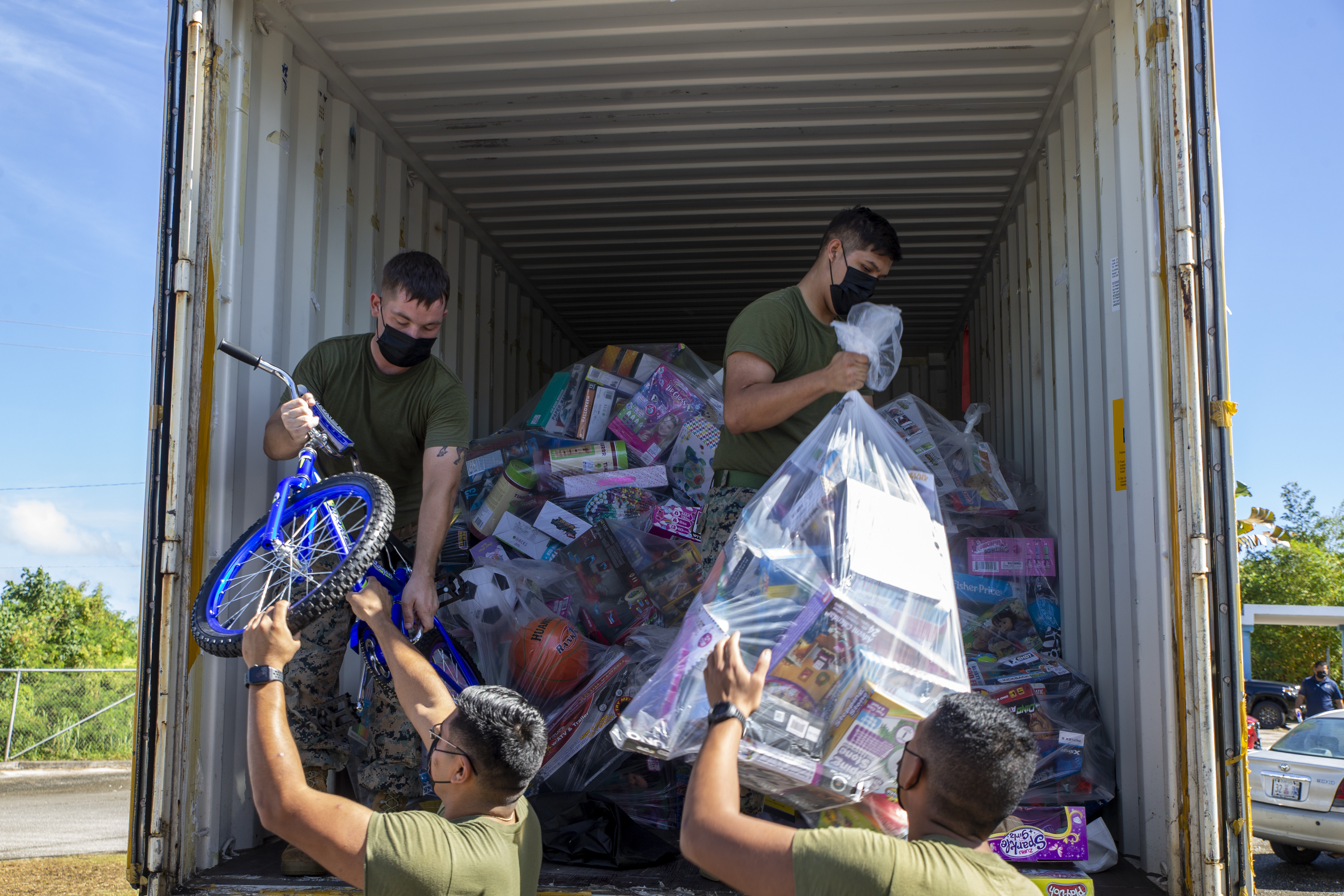 U.S. Marines assigned to Marine Corps Base (MCB) Camp Blaz unload toys during a Toys for Tots toy transfer event to local charities on Guam, Dec. 17, 2021.