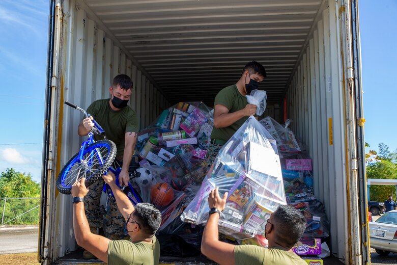 U.S. Marines assigned to Marine Corps Base (MCB) Camp Blaz unload toys during a Toys for Tots toy transfer event to local charities on Guam, Dec. 17, 2021.