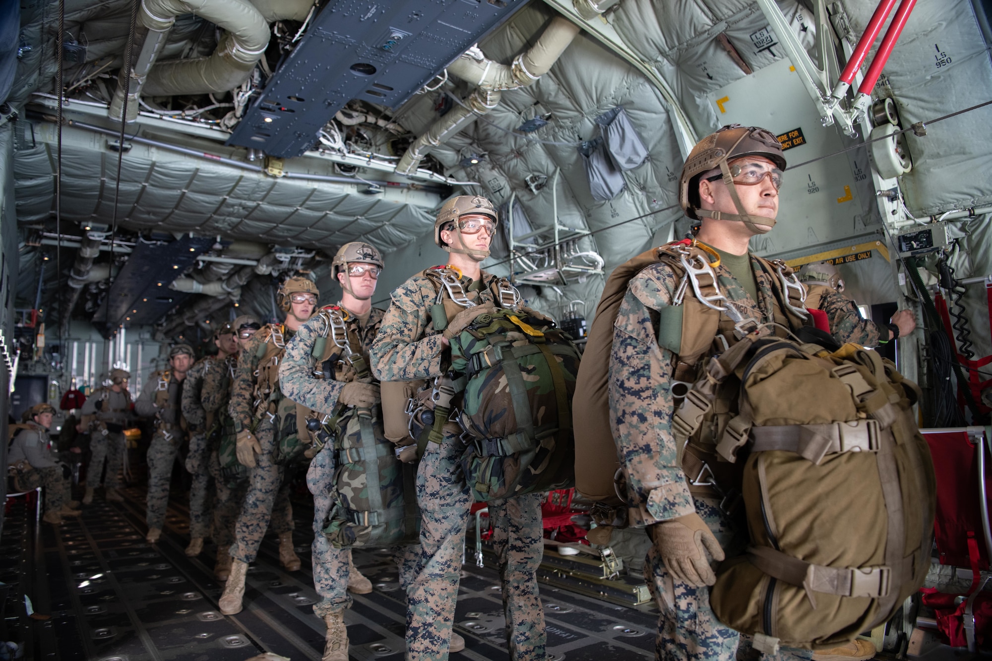 Marines assigned to the 3rd Reconnaissance Battalion, 3rd Marine Division, stand single-file within a 36th Airlift Squadron C-130J Super Hercules during high altitude, low opening (HALO) parachute jumps at Yokota Air Base, Japan, Dec. 17, 2021.