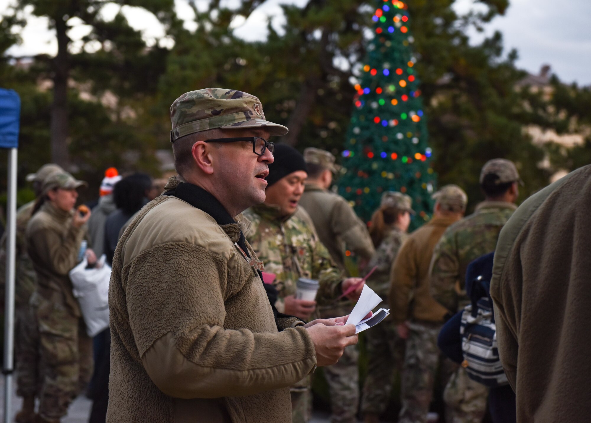 Service members and families sing Christmas carols.