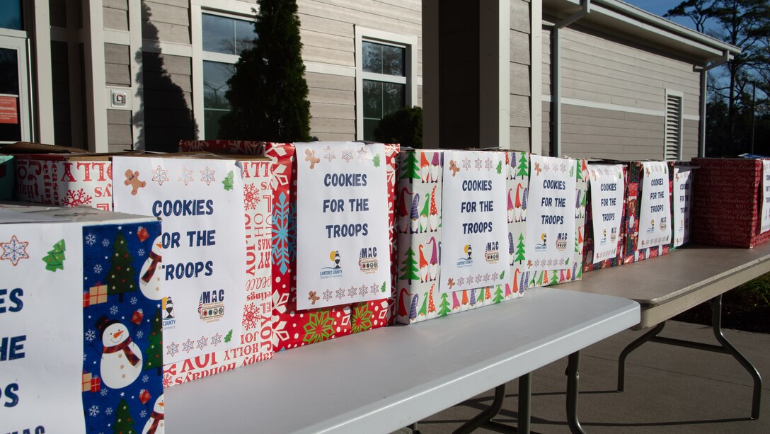 Members of the Carteret County Chamber of Commerce Military Affairs Committee distribute the cookies as a sweet reminder that the community appreciates the sacrifices service members make, especially during the holiday season.