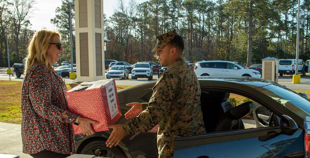 Members of the Carteret County Chamber of Commerce Military Affairs Committee distribute the cookies as a sweet reminder that the community appreciates the sacrifices service members make, especially during the holiday season.