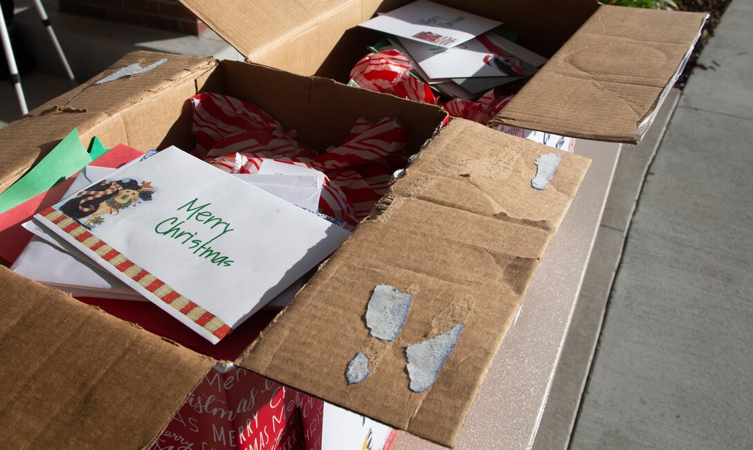Members of the Carteret County Chamber of Commerce Military Affairs Committee distribute the cookies as a sweet reminder that the community appreciates the sacrifices service members make, especially during the holiday season.