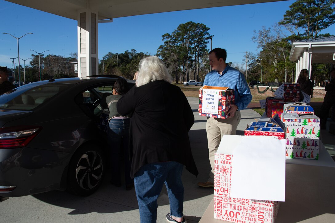 Members of the Carteret County Chamber of Commerce Military Affairs Committee distribute the cookies as a sweet reminder that the community appreciates the sacrifices service members make, especially during the holiday season.