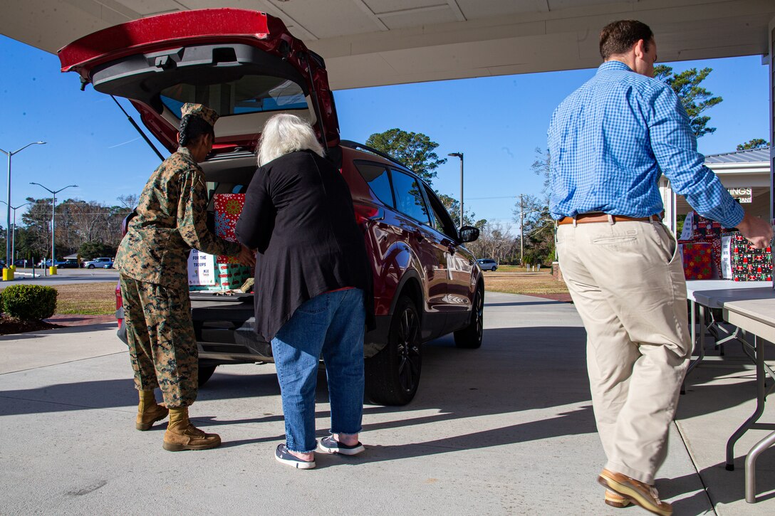 Members of the Carteret County Chamber of Commerce Military Affairs Committee distribute the cookies as a sweet reminder that the community appreciates the sacrifices service members make, especially during the holiday season.