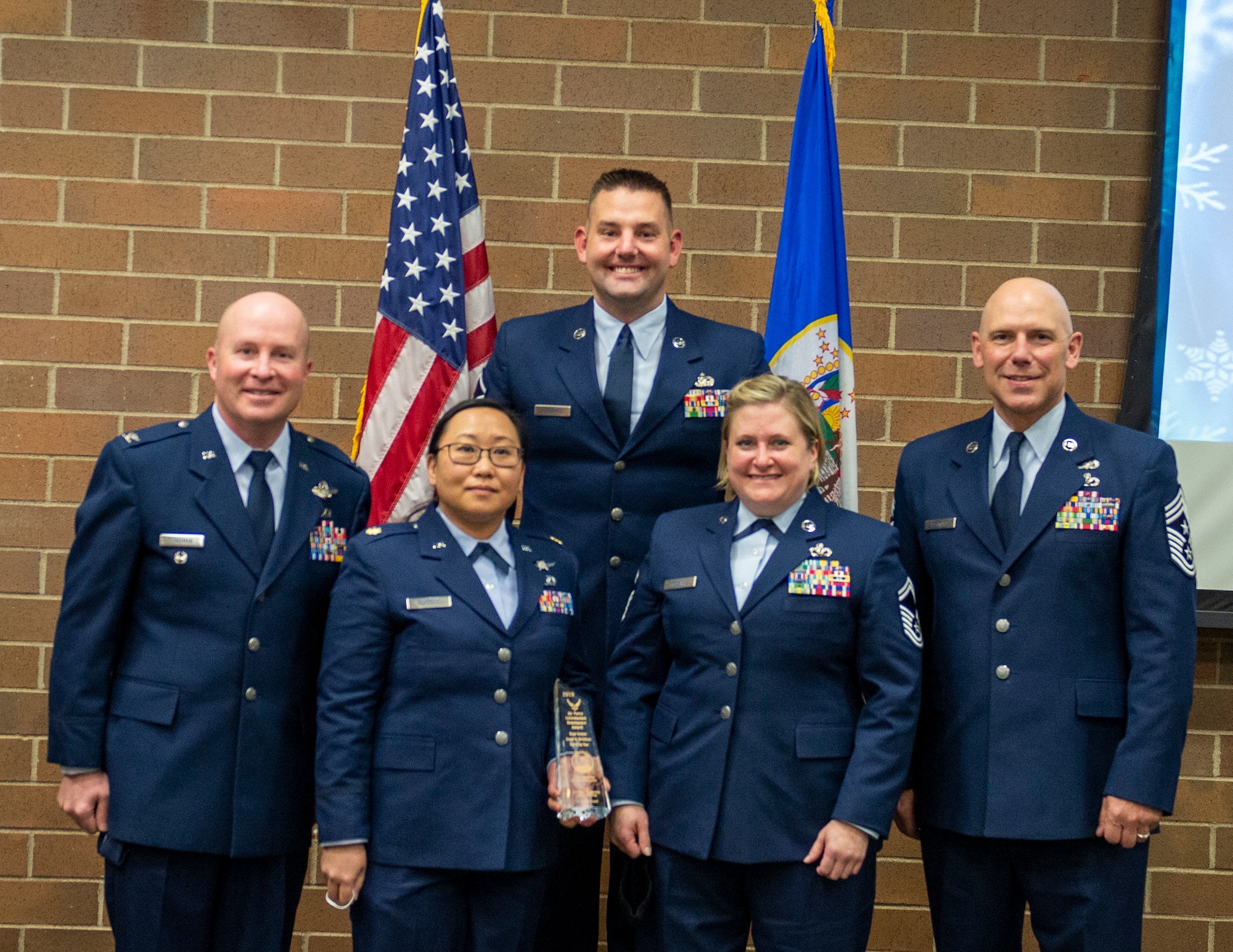 U.S. Air Force Airmen from the 210th Engineering Installation Squadron accept The Air Force General Edwin W. Rawlings Team Award in St. Paul, Minn., Dec. 11, 2021.