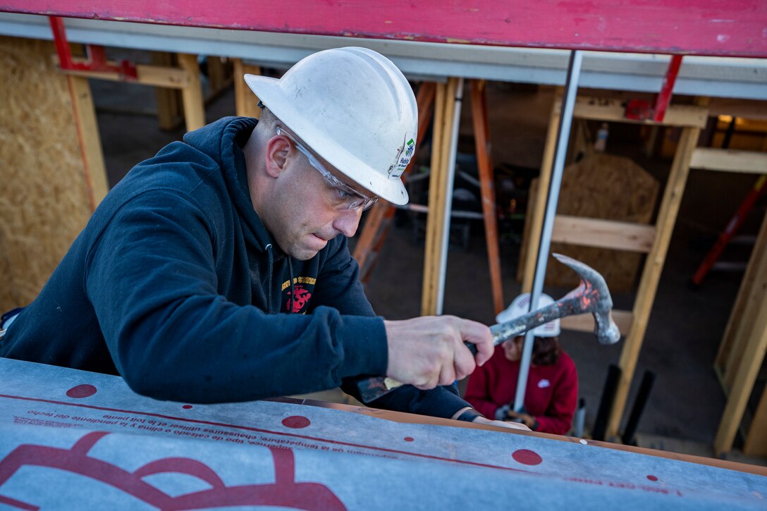 U.S. Marine Corps Staff Sgt. Nicholas Grasso, a canvassing recruiter with Recruiting Substation Arrowhead, hammers a nail on Dec. 11, 2021 in Phoenix, Arizona. The Marines assisted Habitat for Humanity to help out those less fortunate in the local community before the Holidays. Grasso is a native of Selinsgrove, Pennsylvania. (U.S. Marine Corps photo by Cpl. Brennan J. Beauton)