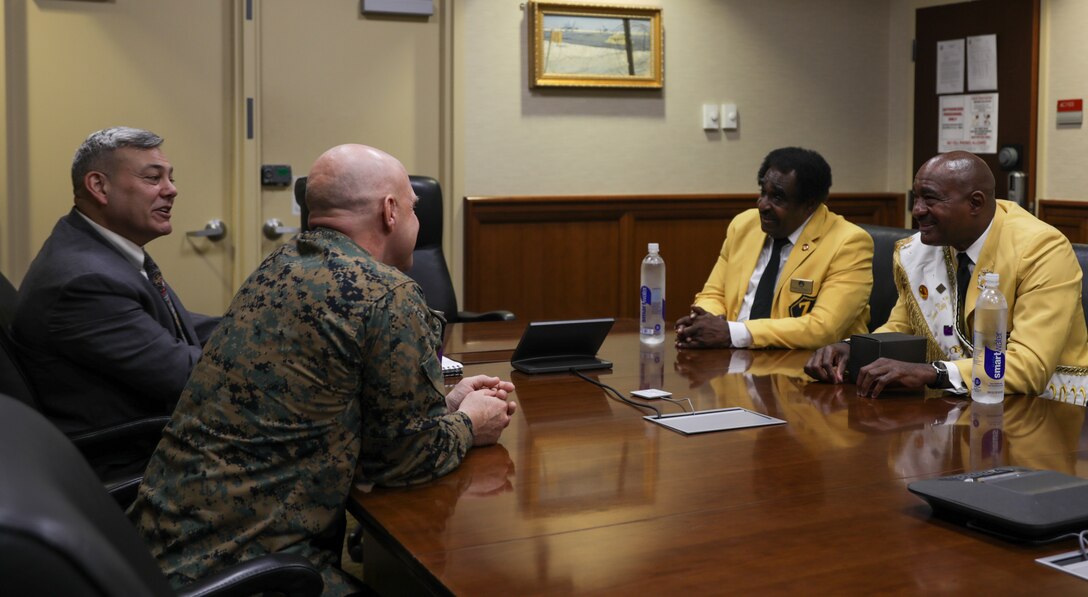Members of the Zulu Social Aid and Pleasure Club and leaders of Marine Forces Reserve converse at Marine Corps Support Facility New Orleans, Dec. 17, 2021. Every year since 2006 the Zulu Social Aid & Pleasure Club has organized toy drives alongside the U.S. Marine Corps Reserve’s Toys for Tots Program. (U.S. Marine Corps photo by Lance Cpl. Leslie Alcaraz)