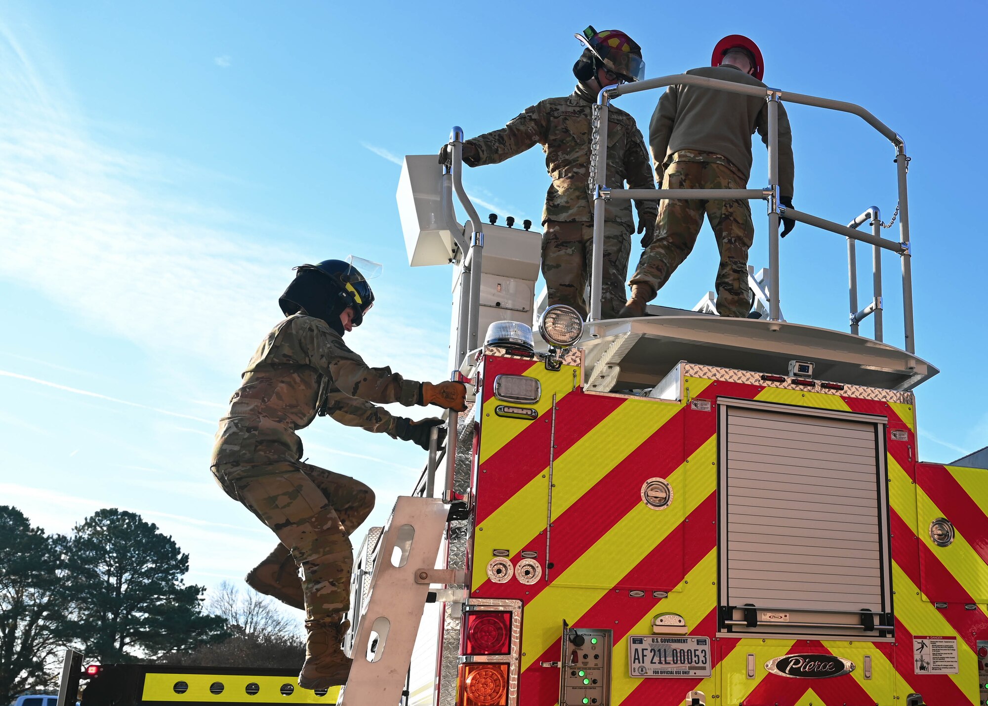 U.S. Air Force Airman 1st Class Kayla French, 633d Civil Engineer Squadron firefighter, climbs a ladder on the Langley Fire Department’s new aerial ladder fire truck at Joint Base Langley-Eustis, Virginia, Dec. 10, 2021.
