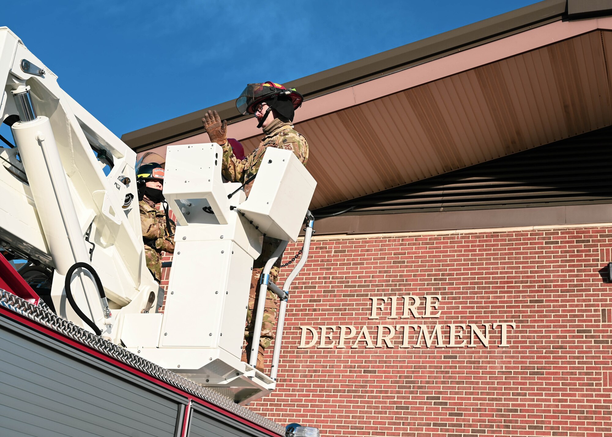 U.S. Air Force Tech. Sgt. Isaac Sunnock, 633d Civil Engineer Squadron station captain, explains the function of the control system on the Langley Fire Department’s new aerial ladder fire truck at Joint Base Langley-Eustis, Virginia, Dec. 10, 2021.