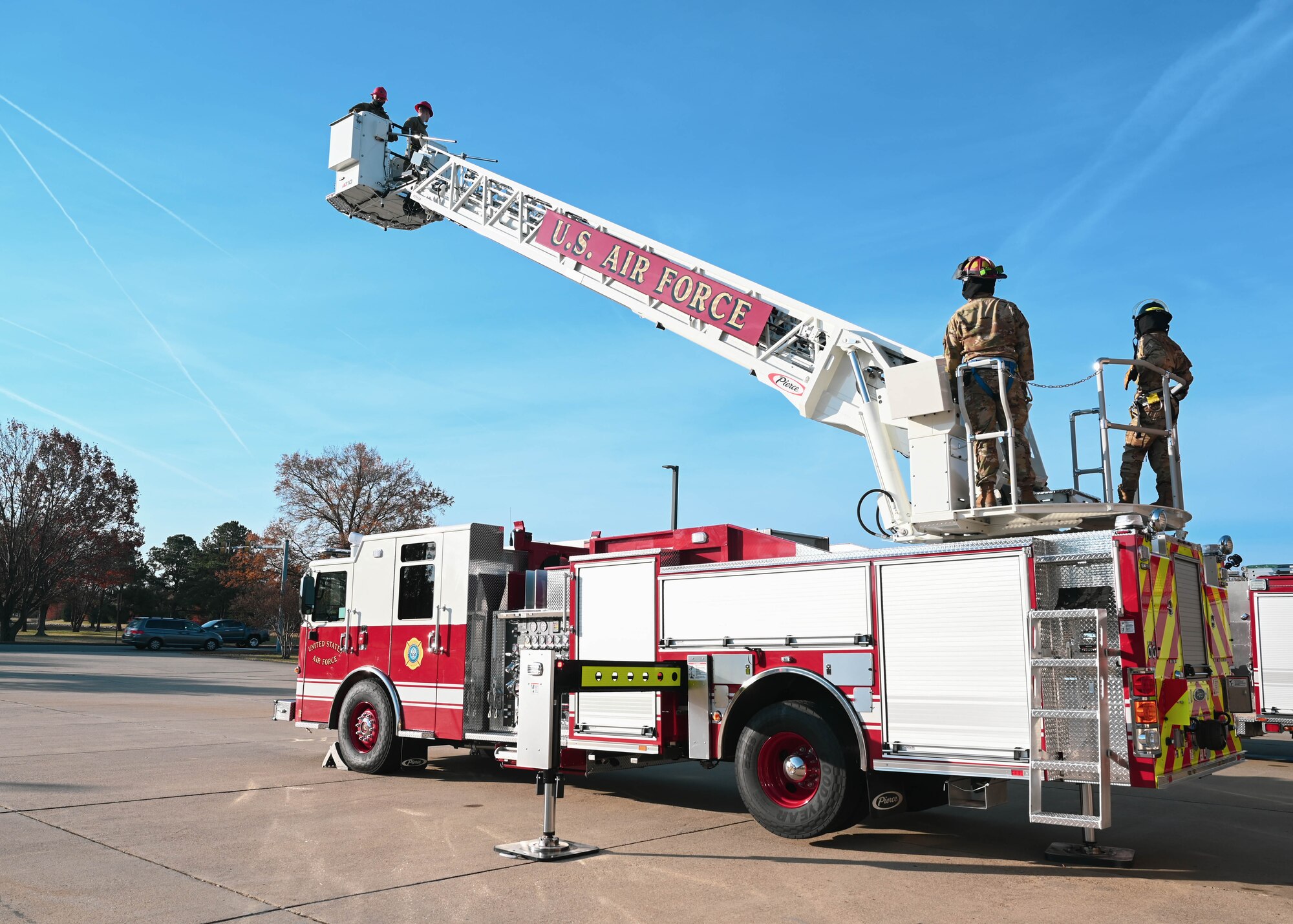 U.S. Air Force Tech. Sgt. Isaac Sunnock, 633d Civil Engineer Squadron station captain, raises the ladder on the Langley Fire Department’s new aerial ladder fire truck at Joint Base Langley-Eustis, Virginia, Dec. 10, 2021.