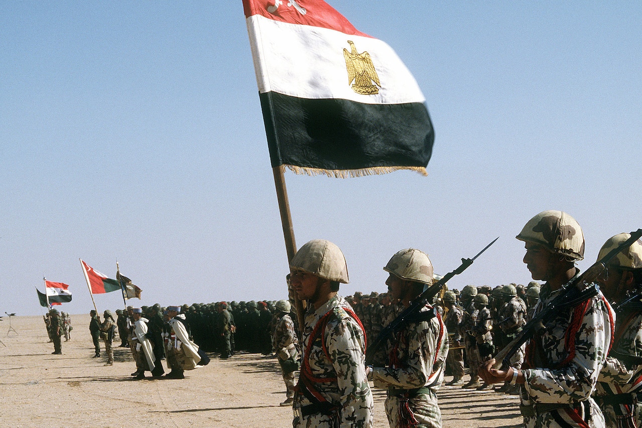 Troops stand in formation.