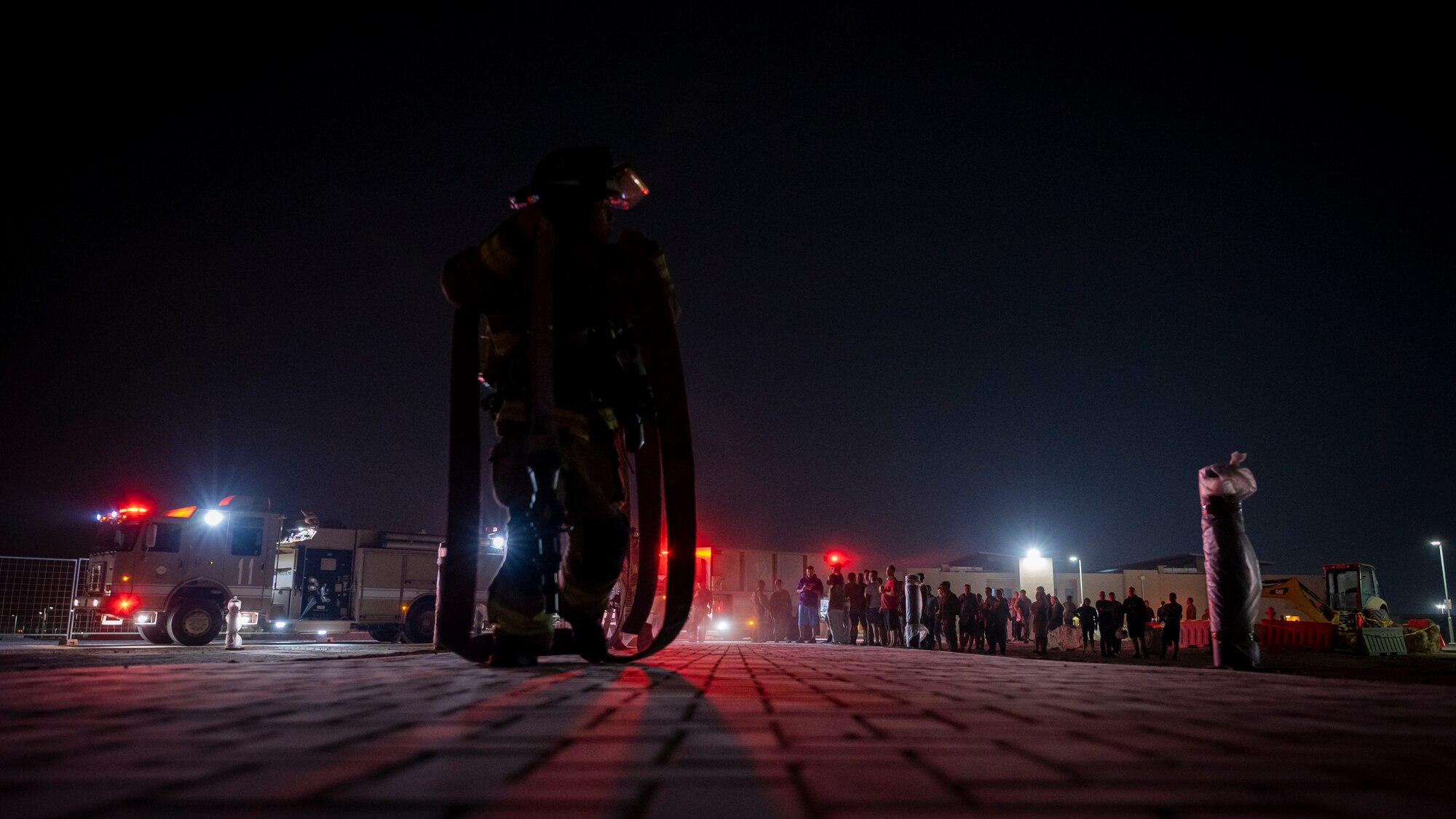 Fire fighters prepare a fire hose during an exercise.