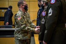 Soldiers shaking hands for recipients.