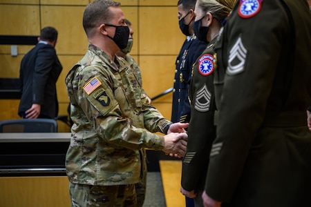 Soldiers shaking hands for recipients.