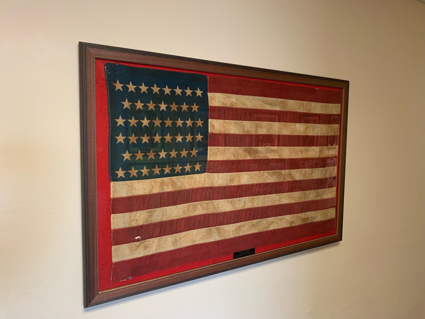 Framed flag with 46 stars.