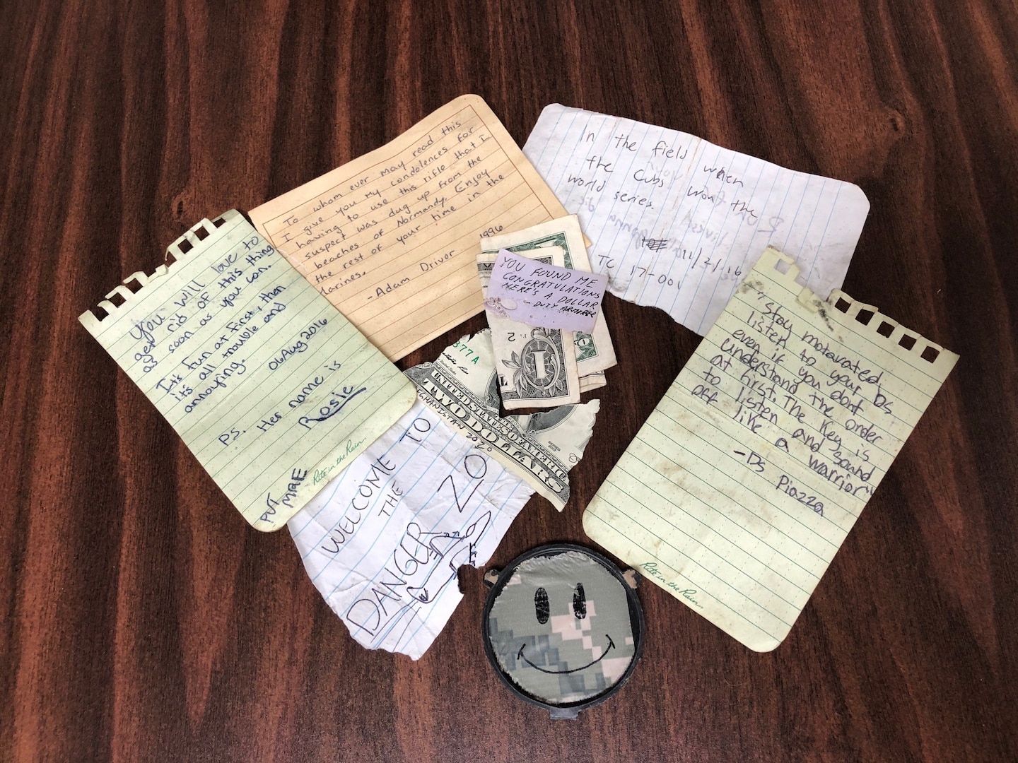 Multiple handwritten notes of encouragement displayed on a table