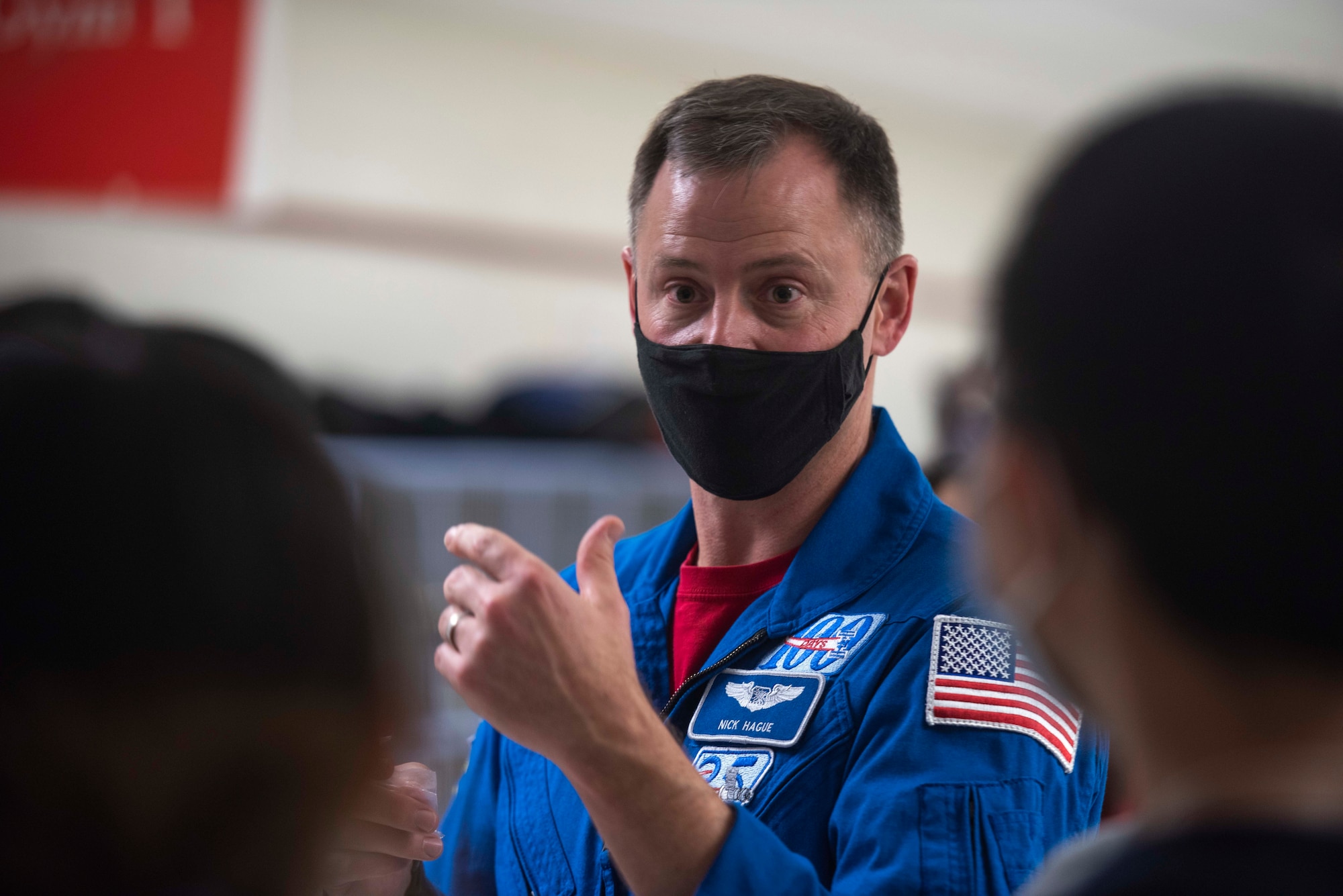 NASA astronaut and Space Force Col. Nick Hague speaks with a student during a "STEM to Space" visit at Thomas Jefferson High School in Alexandria, Va., Dec. 15, 2021. STEM to Space started as a small team project to celebrate the first Space Force birthday with the initial intent to get out into the local D.C. area to meet with classrooms and talk about the service and STEM, and grew to reach more than 66,000 students in all 50 states, Washington D.C., Puerto Rico, Guam, South Korea, Japan, Belgium, Germany, the United Kingdom, and Italy in its second year. (U.S. Air Force photo by Staff Sgt. Jeremy L. Mosier)