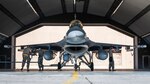 Airmen from the 378th Expeditionary Maintenance Squadron prepare to load munitions onto an F-16 Fighting Falcon at King Fahad Air Base, Kingdom of Saudi Arabia, Dec. 7, 2021. U.S. F-16s integrated with Royal Saudi Air Force F-15s to strengthen and reinforce air defenses against any potential threats. (U.S. Air Force photo by Senior Airman Jacob B. Wrightsman)