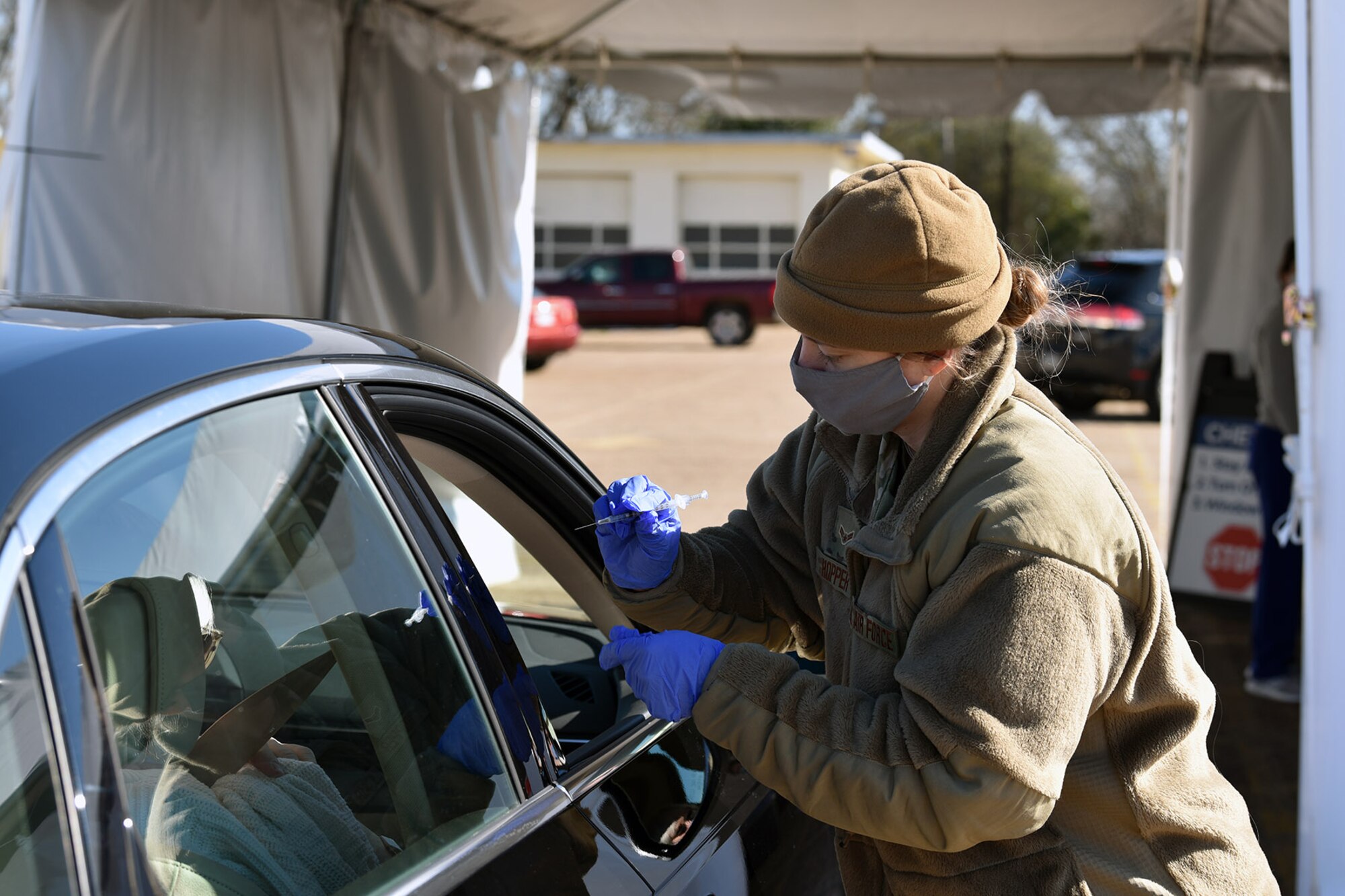 A member of the Louisiana National Guard prepares to vaccinate a citizen at a drive-thru COVID-19 vaccination site in January 2021. As of December 2021, the LANG had vaccinated 192,596 and tested 498,122 people throughout the state.