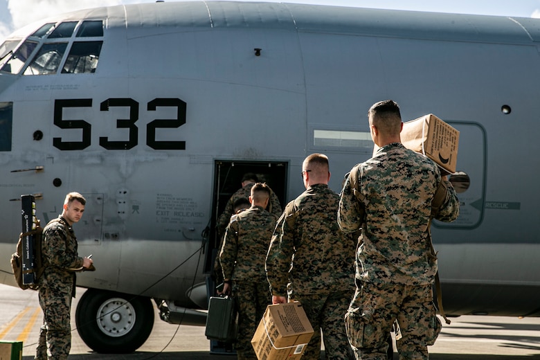 U.S. Marines and Sailors with Combat Logistics Regiment 3, 3rd Marine Logistics Group, board a U.S. Air Force C-130 Hercules at Kadena Air Base, Japan, Dec. 6, 2021. Marines with CLR-3 are providing support services such as field expedient showers and laundry facilities to the residents of Joint Base Pearl Harbor-Hickam affected by the ongoing water issue. 3rd MLG, based out of Okinawa, Japan, is a forward deployed combat unit that serves as III MEF’s comprehensive logistics and combat service support backbone for operations throughout the Indo-Pacific area of responsibility.