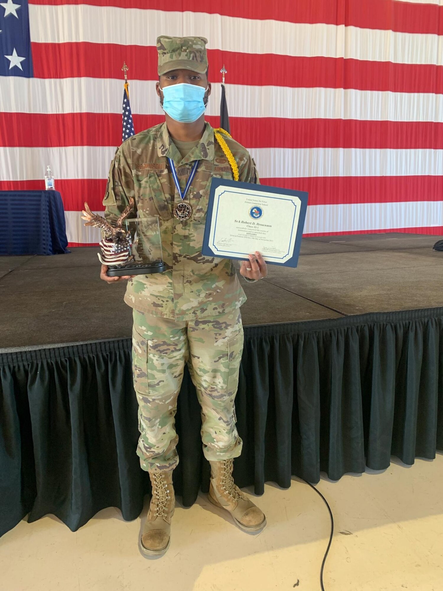 U.S. Air Force Senior Airman Robert Brownson, 50th Mission Support Group contracting specialist, stands with his John Levitow Award after the Airmen Leadership School Graduation Ceremony at Peterson Air Force Base, Colorado, Nov. 19, 2021.