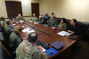 photo of U.S. Airmen sitting at a conference table