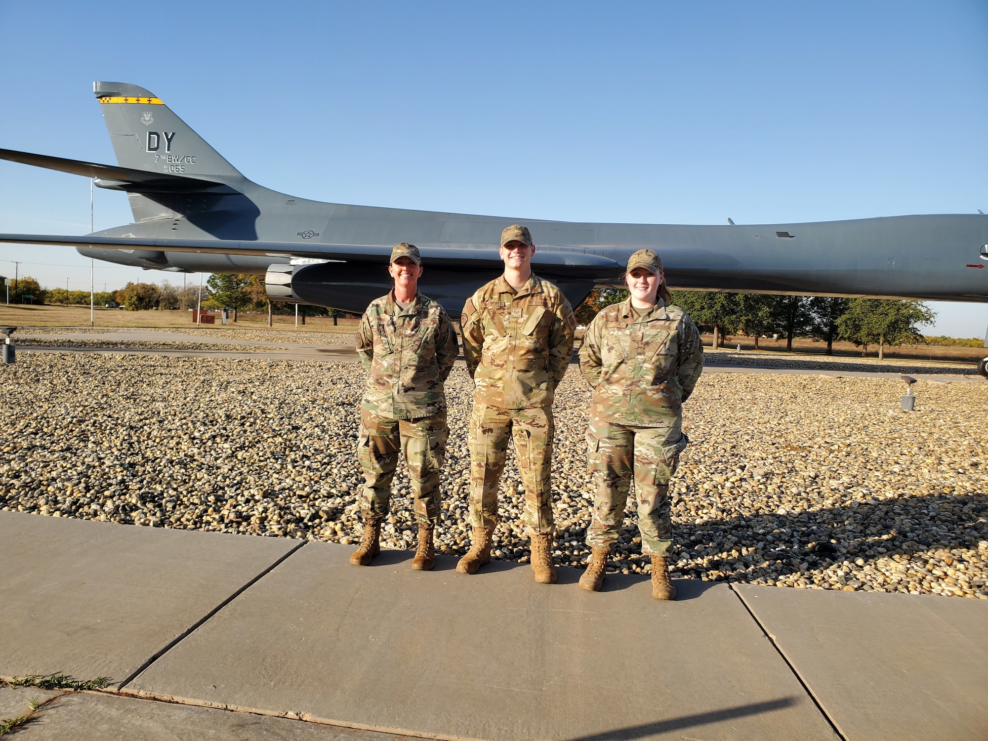 Staff Sgt. Aaron Marriott, 7th Civil Engineer Squadron firefighter, center, poses in front of a B-1 Lancer static display with his mother Senior Master Sgt. Daneen Jeziorske, the Air Force Global Strike Command command mental health functional manager, left, and sister Senior Airman Caitlyn Jeziorske, 7th Component Maintenance Squadron command support staff, right, at Dyess Air Force Base, Texas, Nov. 17, 2021.