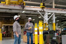 Photo of  Michael Lazowski and Darren Stout preparing to conduct operability testing on an overhead crane.