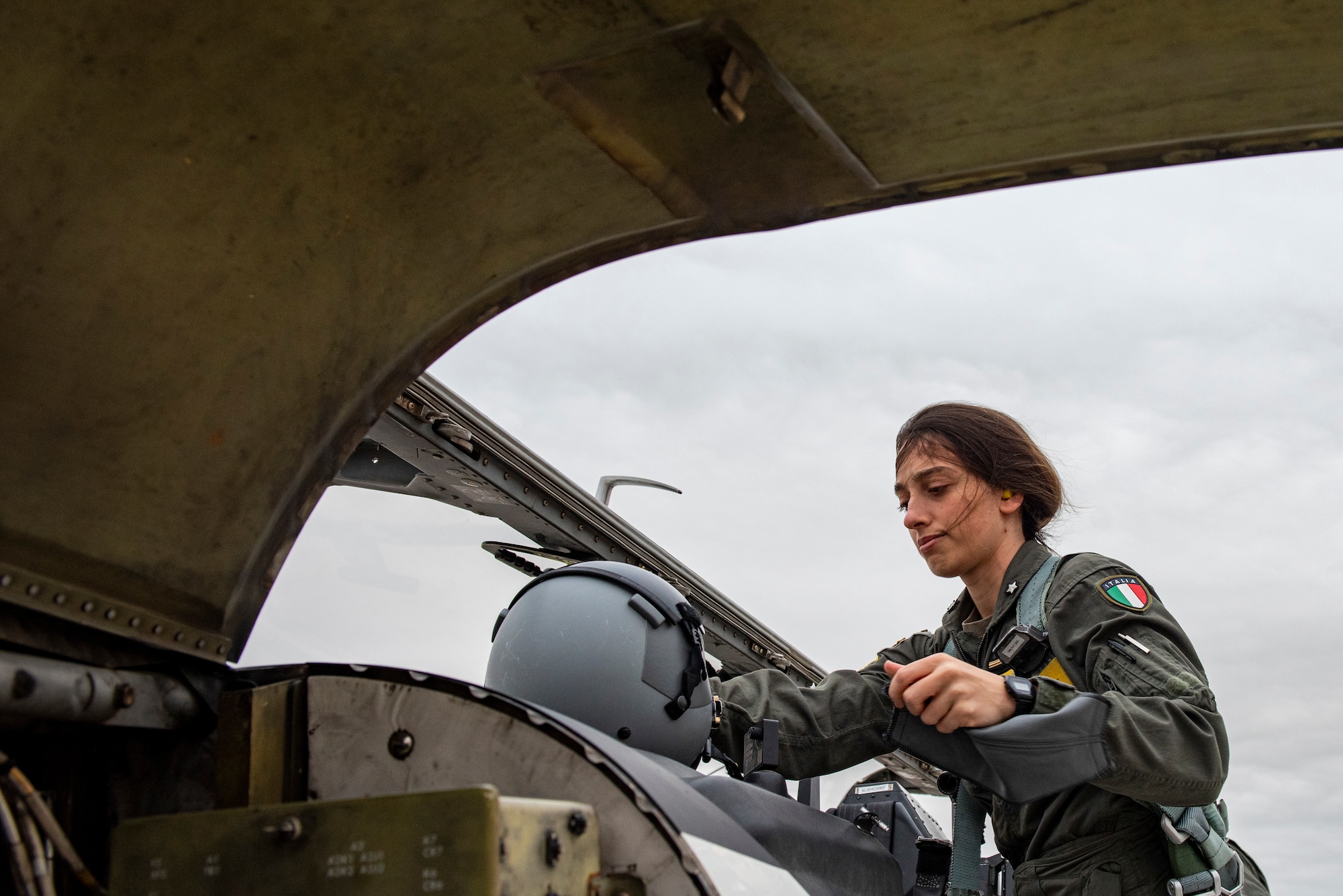 2nd Lt. Rosaria, 47th Flying Training Wing international student pilot, places her helmet on the center conceal of the aircraft while adjusting her gear before entering the airframe. Carluccio is a member of the Italian Air Force and is currently at Laughlin for pilot training before going back home to be assigned an aircraft to fly. (These photos have been edited to hide the last name of the student) (U.S. Air Force photo by Senior Airman David Phaff)